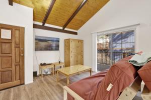 a bedroom with a wooden door and a table at 2358- Oso Grande cabin in Big Bear Lake