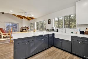 a kitchen with blue cabinets and white counter tops at 2358- Oso Grande cabin in Big Bear Lake