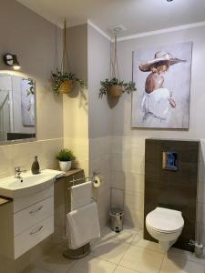 a bathroom with a toilet and a sink at Apartamenty EDK in Jelenia Góra