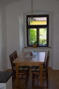 a dining room table with chairs and a window at Chalupa lipovka 
