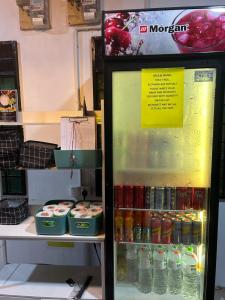 a refrigerator filled with lots of drinks in a store at MIMPIMOON HOSTEL Langkawi in Pantai Cenang