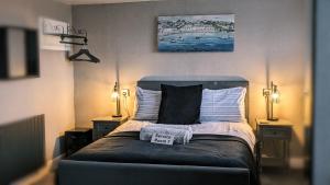 a bedroom with a bed with a sign on it at Croyland Guest House in Tenby +40 photos