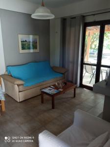 a living room with a bed and a coffee table at Katerina's SeaSide in Afissos