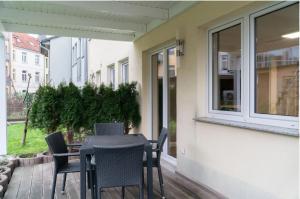 a patio with a table and chairs on a porch at Annalena in Schwerin