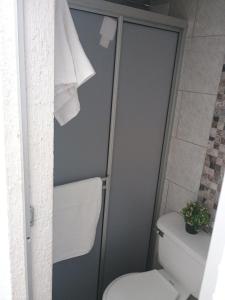 a bathroom with a toilet and a shower stall at Alojamiento valerie in Neiva +7 photos