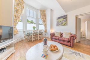 A seating area at Enjoy relaxing family breaks in this central Ambleside apartment with parking