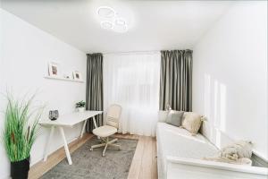 a white living room with a white couch and a desk at Family Stay - Calliope apartment - By OpenHouse in Timişoara