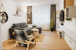 a living room with a couch and a table at Family Stay - Calliope apartment - By OpenHouse in Timişoara