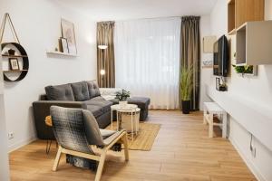 a living room with a couch and a table at High quality family - Calliope apartment in Timişoara
