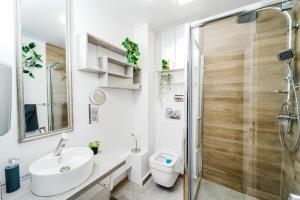 a bathroom with a shower and a sink and a toilet at High quality family - Calliope apartment in Timişoara