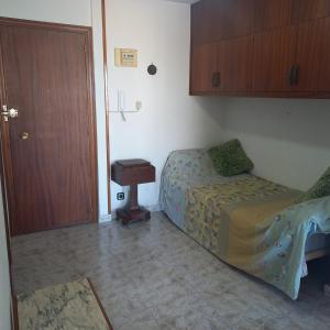 a bedroom with a bed and a table and a door at VISTAS PLAYA - Torre San Jordi in Alicante