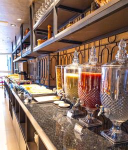 a buffet line with wine glasses on a counter at Place2You Hotel by Welkom in João Pessoa