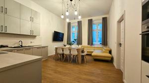 a kitchen and living room with a table and chairs at Apartmán Maxmilián**** s parkováním zdarma in Karlovy Vary
