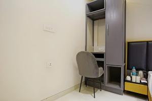 a room with a chair and a television at Hotel Apple Suite Residency - Free Airport Transffer in New Delhi