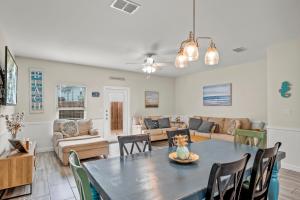 a dining room and living room with a table and chairs at Kia Ora Casita in Port Aransas