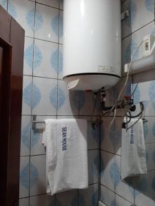 a bathroom with a towel dispenser on a wall at HOTEL KEUTCHA in Douala