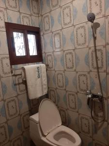 a bathroom with a toilet and a shower at HOTEL KEUTCHA in Douala