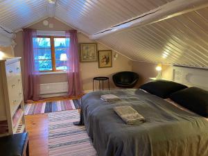 a bedroom with a large bed and a window at Villa Wargquist in Djuras