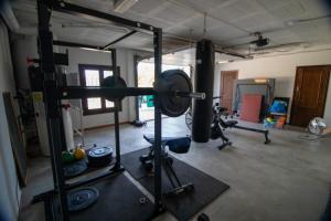 a gym with several equipment in a room at Villa Mantequilla in Alora