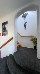 a hallway with a staircase with a cat on the wall at Kiek Inn in Hitzacker