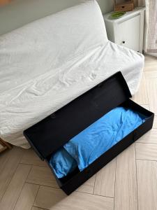 a bed with a box on the floor at Casa del sasso in Bergeggi