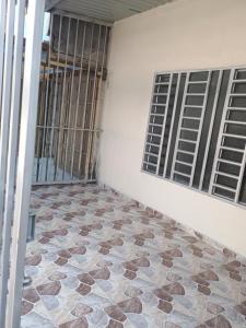 a room with a tiled floor and two windows at Alojamiento Valerie in Neiva