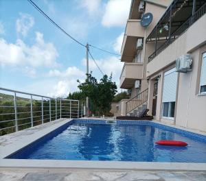 a swimming pool with a red frisbee next to a building at Apartment Cezar in Krimovice