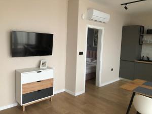 a living room with a flat screen tv on a wall at Buena Vista Villas in Varna City