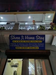 a sign for a home stay on a building at SHREE JI HOMESTAY in Rishīkesh