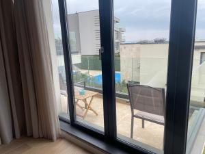 a room with a window and a chair on a balcony at Buena Vista Villas in Varna City