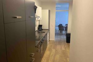 a kitchen with a sink and a refrigerator at Apartment in Langenhagen-Airport-Hannover! contactless check-in in Hannover
