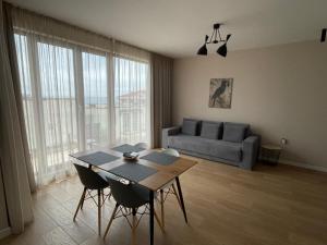 a living room with a table and a couch at Buena Vista Villas in Varna City