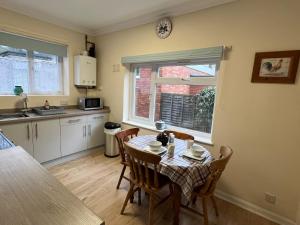 a kitchen and dining room with a table and chairs at Large Ground floor apartment in the heart of Church Stretton with free parking in Church Stretton