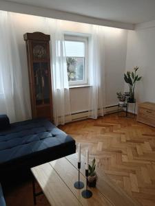 a living room with a bed and a table with candles at Ferienwohnung Allgäu 2 in Memmingen