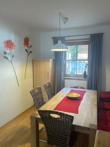 a dining room table and chairs with a table and a dining room at Ferienwohnung Carpe Diem - a89500 in Walchensee