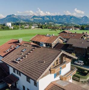 an aerial view of roofs of houses and a field at Ferienwohnung Alpenvogel in Sonthofen