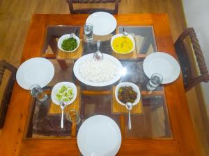 an overhead view of a table with bowls of food at Hill House Haldummulla in Badulla +31 photos