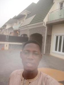 a young man standing in front of a house at Cis service apartment in Ketti