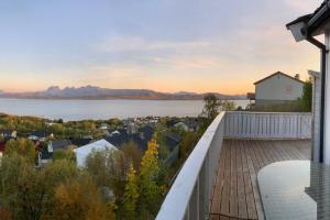 a house with a balcony with a view of the water at Panorama view! Modern,Balcony/parking in Bodø