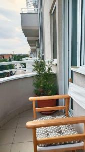 a wooden bench sitting on the balcony of a building at Apartmani Beograd - Light Oasis in Belgrade