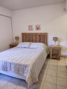 a bedroom with a bed and two end tables at Dpto Catedral in Salta