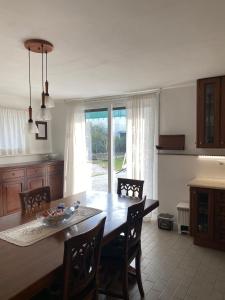 a kitchen with a wooden table and a dining room at Stella House in Crevalcore +12 photos