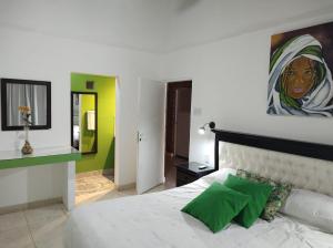a bedroom with a bed with a painting on the wall at Sueño de Termas in Termas de Río Hondo +30 photos