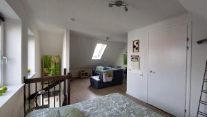 a bedroom with a bed and a living room at Honte 2 in Dishoek
