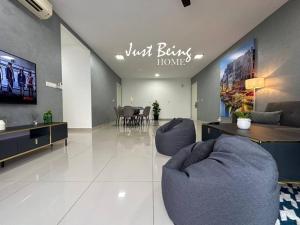 a living room with two blue chairs and a dining room at JBH Family Suite for 6pax King/Queen/Single/Sofa in Kuala Lumpur