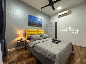 a bedroom with a bed with a yellow headboard at JBH Family Suite for 6pax King/Queen/Single/Sofa in Kuala Lumpur