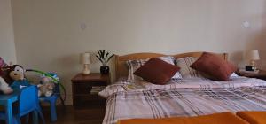 a bedroom with a bed with a teddy bear on it at Holiday house and apartments Vale in Duga Resa