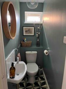 a small bathroom with a toilet and a sink at Bright flat in the heart of Chichester in Chichester