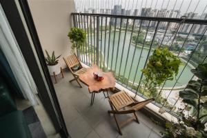 d'un balcon avec une table et des chaises et une vue sur l'eau. dans l'établissement Troy House - Serviced Apartment - DCapitale, à Hanoï