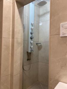 uma casa de banho com um chuveiro e uma porta de vidro em Santa Cruz 5761 em Mar del Plata